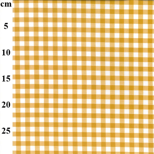 A close-up of a yellow and white gingham checkered fabric pattern with a vertical cm measurement scale on the left side.