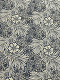 A close-up of a repeating floral and leaf pattern in dark navy blue and warm off-white, filling the entire frame.