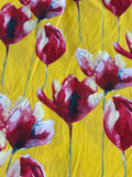 Yellow fabric with a watercolor-style floral print featuring red, burgundy, and white tulip-like flowers with thin green stems.
