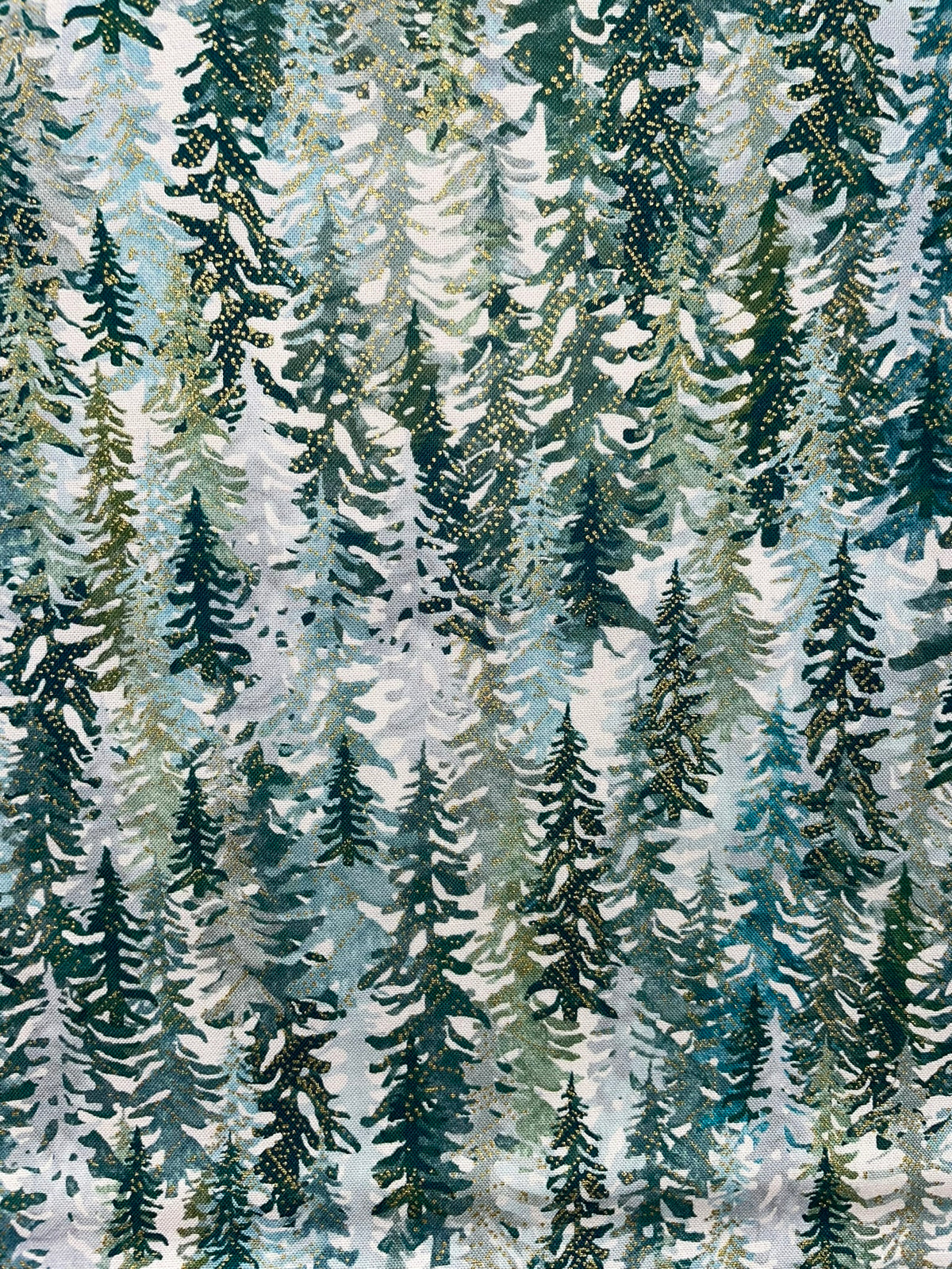 A repeating pattern of tall evergreen trees in shades of dark green, teal, and soft sage on a light off-white background.