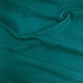 A close-up of draped teal fabric with soft folds and a smooth texture.