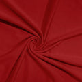 A close-up of red fabric arranged in a spiral drape, showing the material's texture and color.