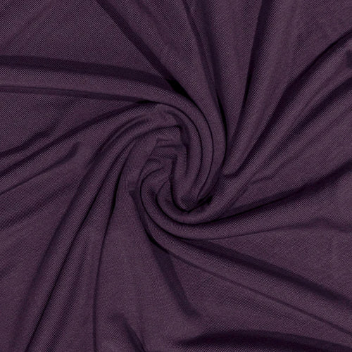 A close-up of dark purple fabric arranged in a spiral drape, showing the material texture and color.