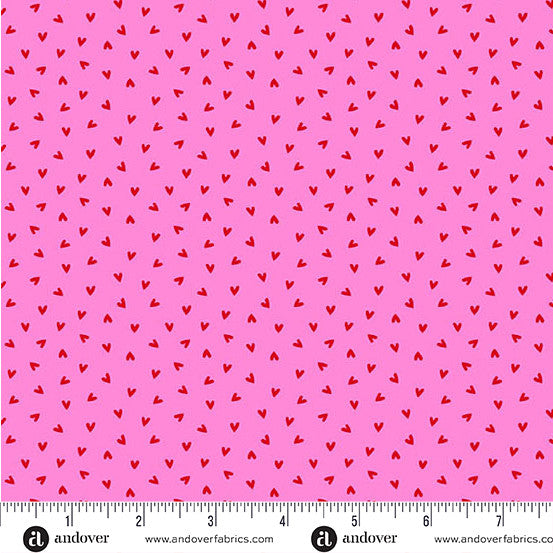 Pink and white geometric pattern fabric with a ruler for scale