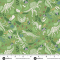 Dinosaur skeleton pattern on green fabric with a ruler for scale.