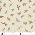 A repeating fabric pattern featuring various cartoon-style dinosaurs in muted brown, tan, gray, and green tones on a warm beige background. A white measurement ruler with black markings is shown along the bottom edge, and the brand name 'andover' appears at the bottom.