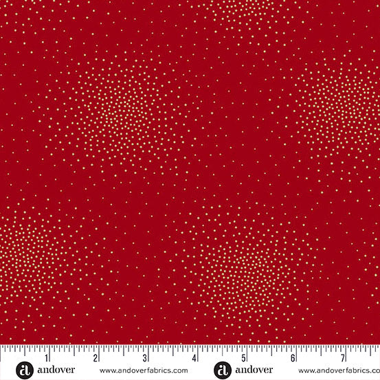 Red fabric with a repeating pattern of small gold dots, shown flat with a white measurement ruler along the bottom edge displaying the scale.