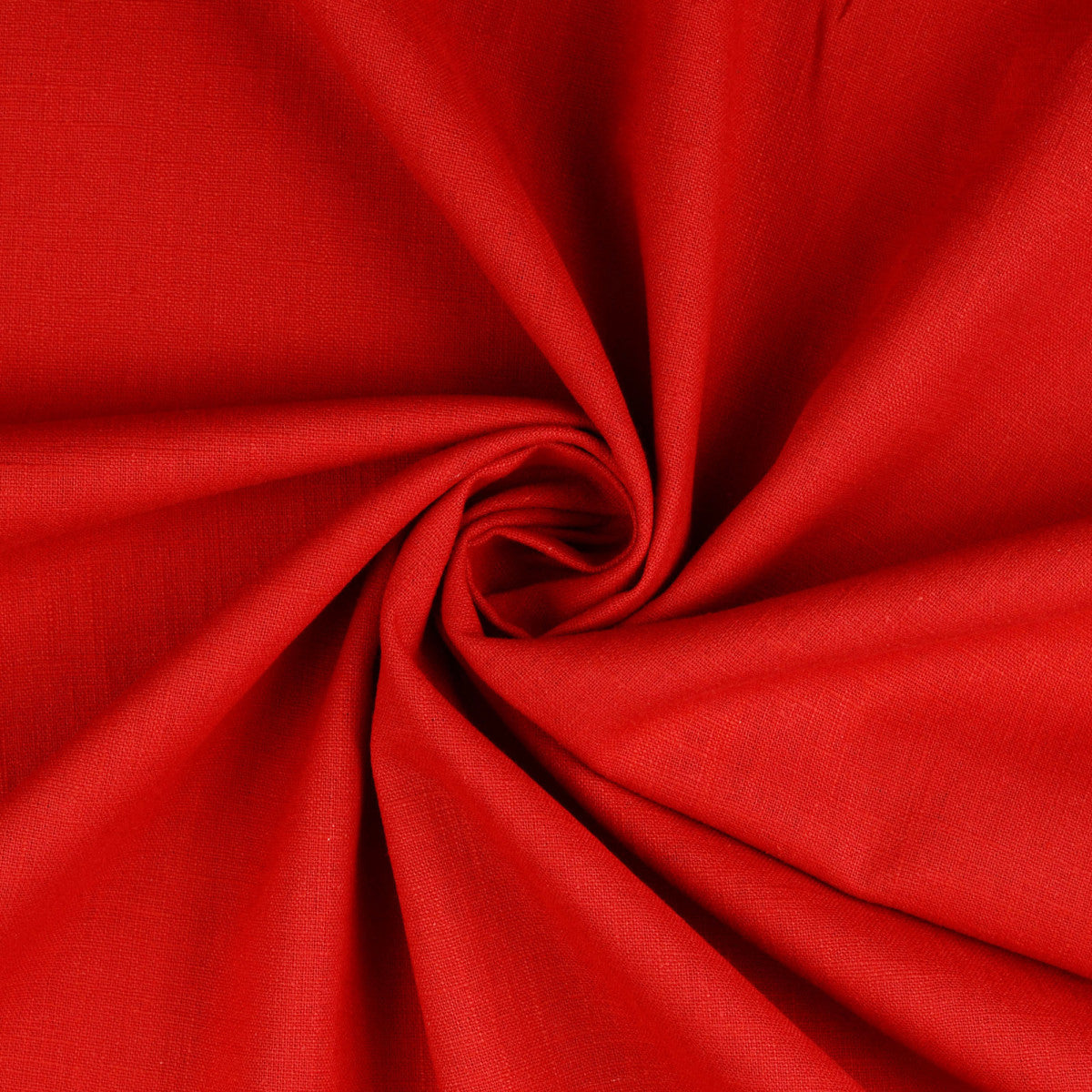 A close-up of bright red linen fabric arranged in a spiral swirl, showing the material texture and drape.