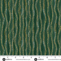 Dark green fabric with a repeating pattern of vertical wavy lines decorated with dotted rows of gold, white, and light green beads. A white measurement ruler is visible along the bottom edge with the brand name 'andover' printed on it.